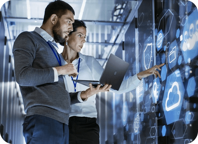 Two people are looking at a computer screen.